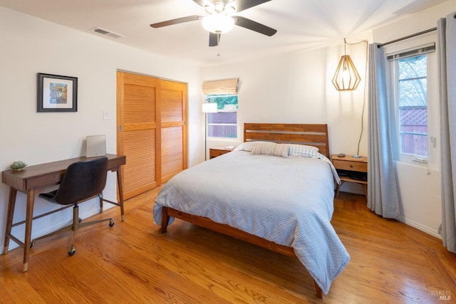 bedroom featuring a closet, ceiling fan, and light hardwood / wood-style flooring