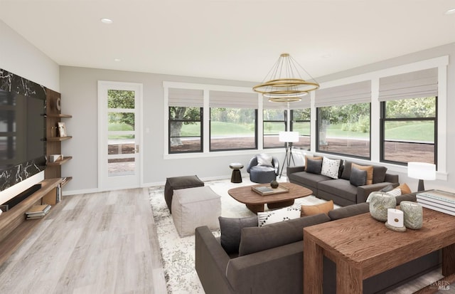 living room with light hardwood / wood-style floors and a chandelier