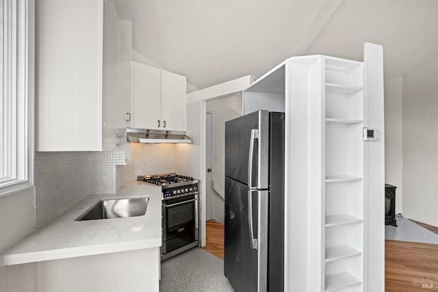 kitchen featuring white cabinets, appliances with stainless steel finishes, under cabinet range hood, open shelves, and a sink