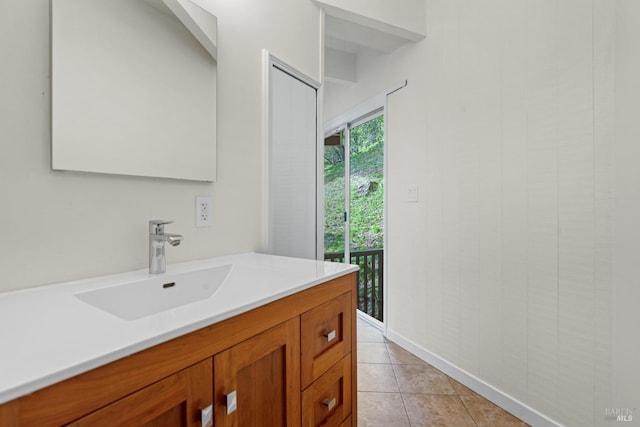 bathroom featuring vanity, baseboards, and tile patterned floors