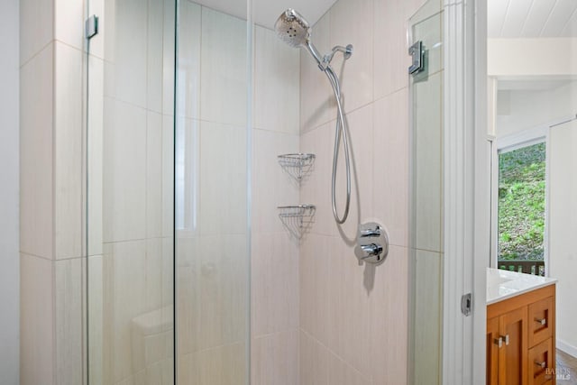 bathroom featuring a shower stall and vanity