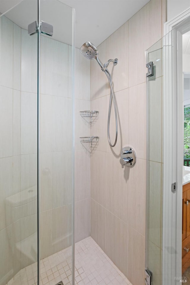 full bathroom with a shower stall and vanity