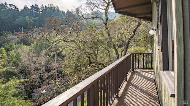 balcony featuring a view of trees