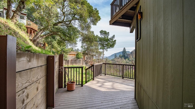 deck featuring fence and a mountain view