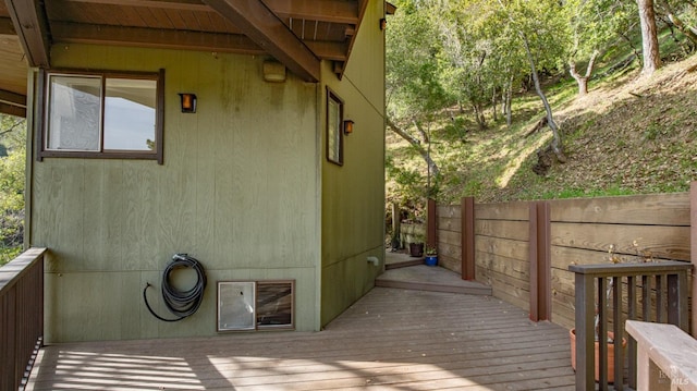 deck featuring fence and radiator heating unit