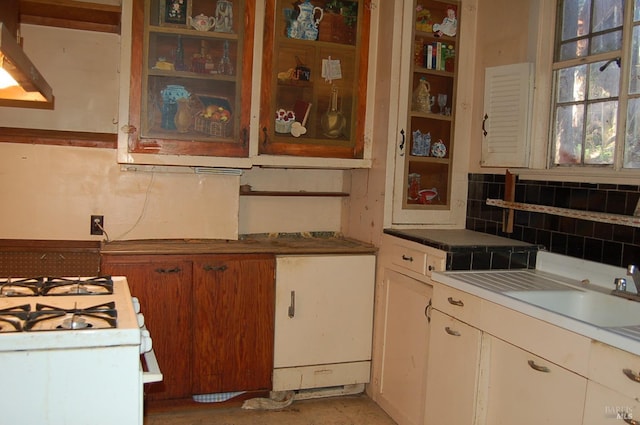 kitchen with tasteful backsplash and white gas stove