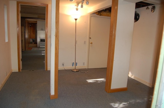 basement featuring dark colored carpet