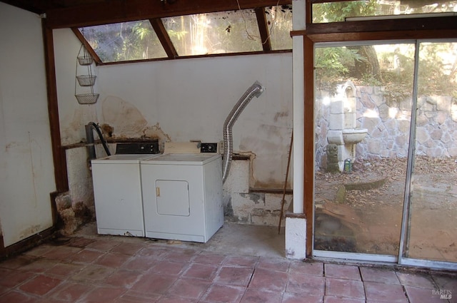 clothes washing area with separate washer and dryer