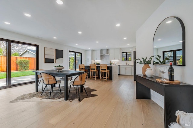 dining room with sink and light wood-type flooring