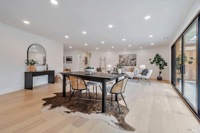 dining space with light hardwood / wood-style flooring