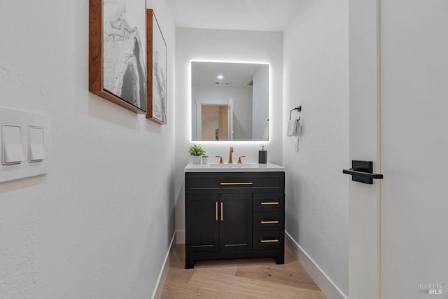 bathroom with vanity and hardwood / wood-style floors