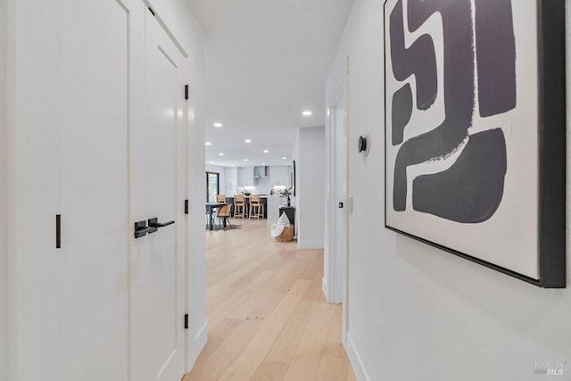 hall with light hardwood / wood-style flooring