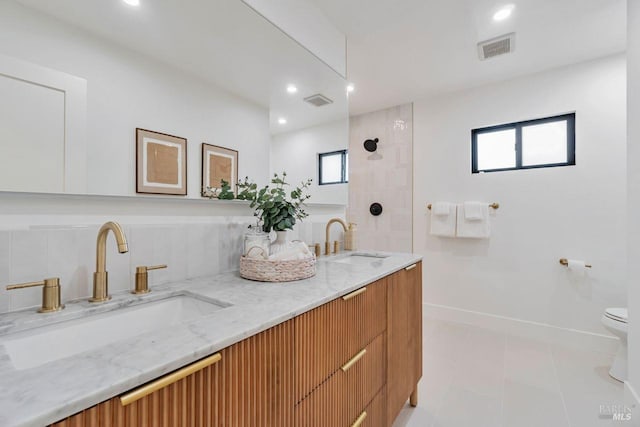 bathroom featuring vanity, tile patterned floors, and toilet