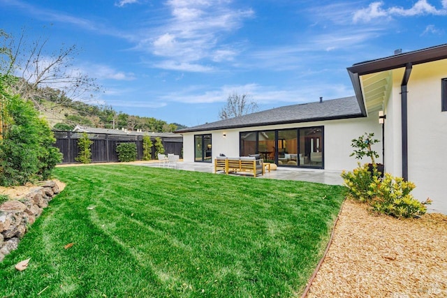 rear view of property with an outdoor living space, a yard, and a patio