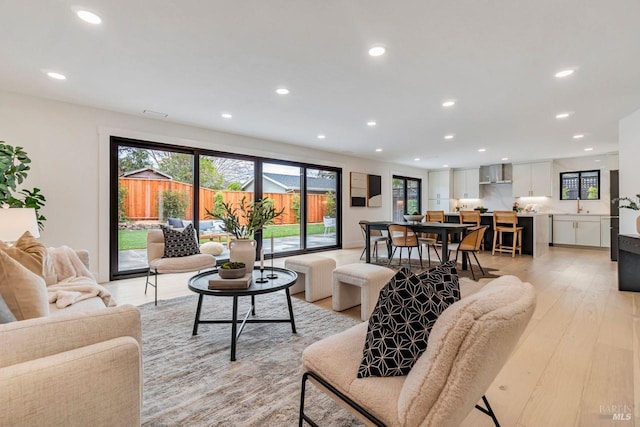 living room with sink and light wood-type flooring