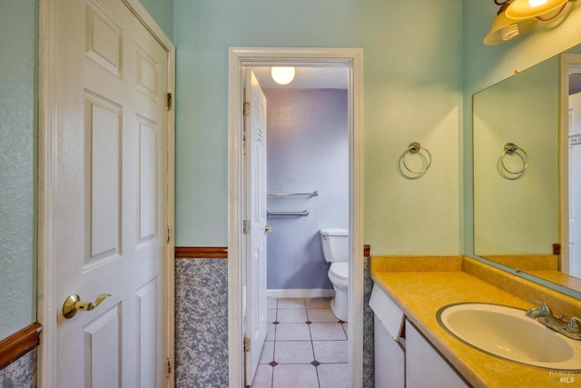 bathroom featuring vanity, tile patterned floors, and toilet