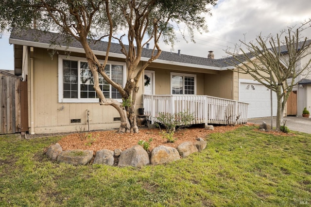 ranch-style home with a garage, a front yard, and a porch