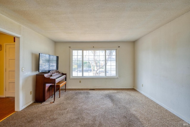 interior space with light colored carpet and a textured ceiling