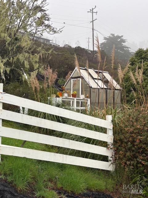 view of gate with an outdoor structure