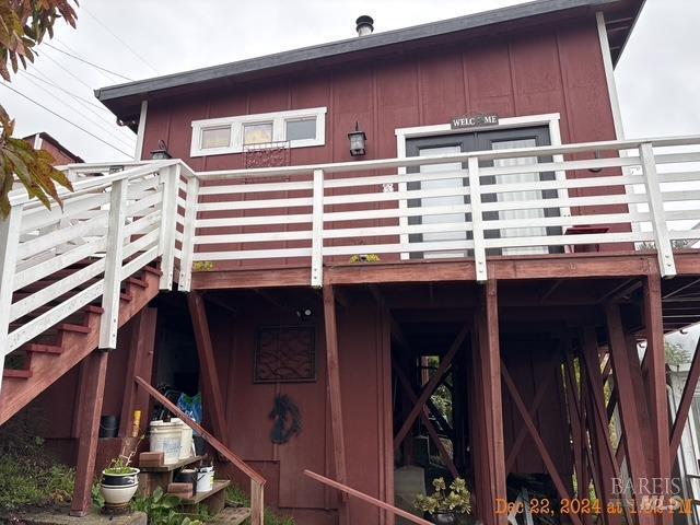 rear view of property featuring a deck