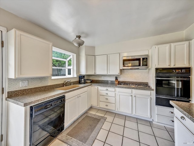 kitchen with backsplash, a sink, a warming drawer, light tile patterned floors, and black appliances