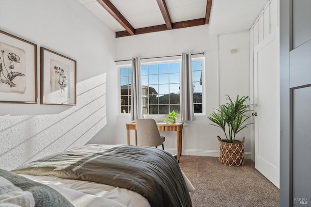 bedroom featuring beamed ceiling and carpet