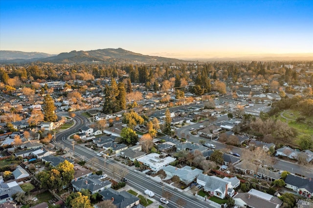 aerial view at dusk featuring a mountain view