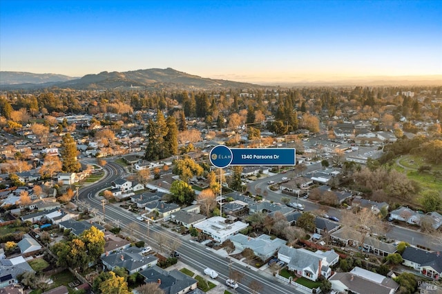 aerial view at dusk featuring a mountain view