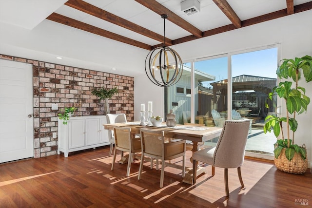 dining space with dark hardwood / wood-style flooring, beam ceiling, a chandelier, and brick wall