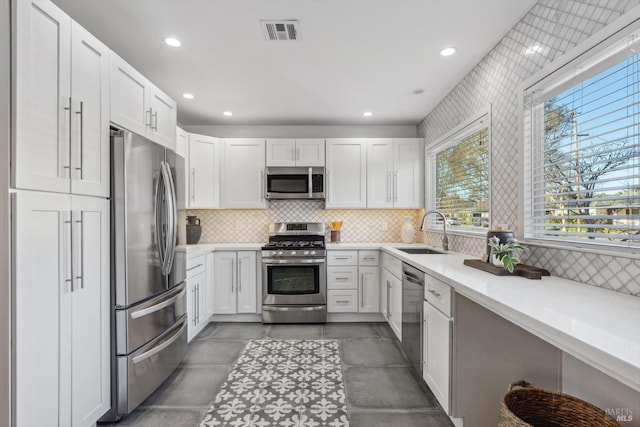 kitchen featuring white cabinetry, appliances with stainless steel finishes, and sink