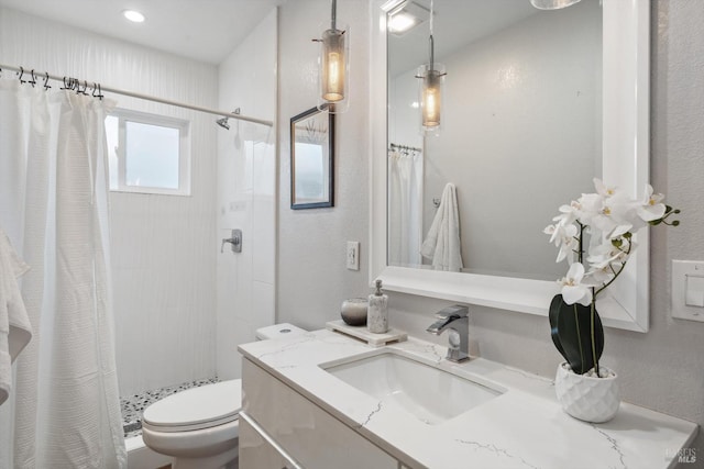 bathroom featuring vanity, curtained shower, and toilet