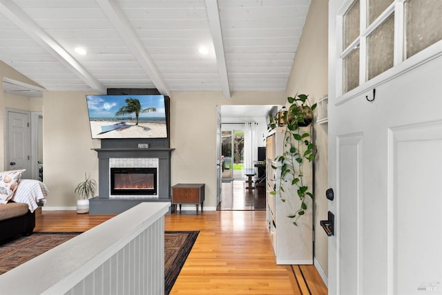 living room with lofted ceiling with beams and hardwood / wood-style floors