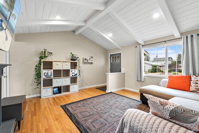 living room featuring lofted ceiling with beams and light wood-type flooring