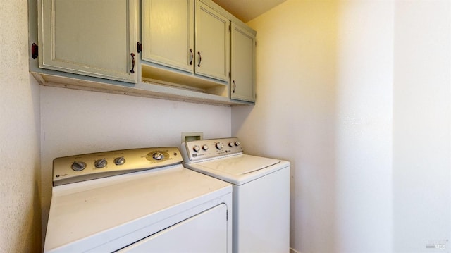 laundry area with cabinets and washer and dryer