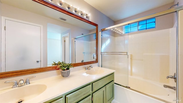 bathroom with vanity and shower / bath combination with glass door