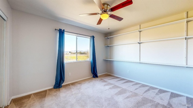 carpeted empty room with ceiling fan