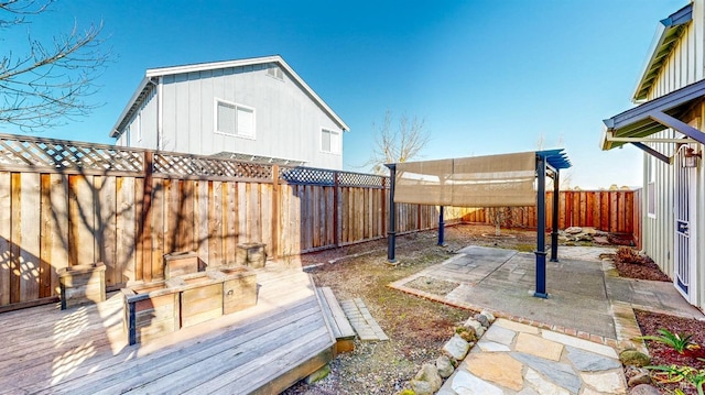 wooden terrace with a patio area