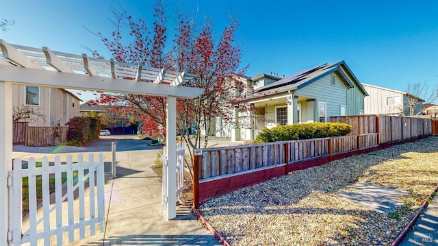 view of side of home with a pergola