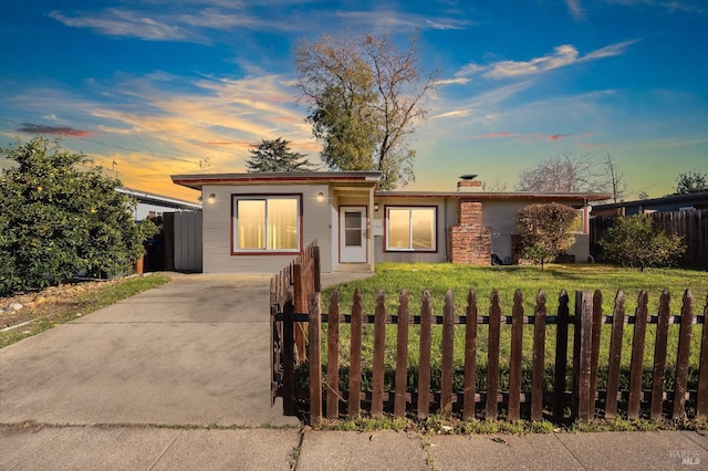 ranch-style house with a lawn