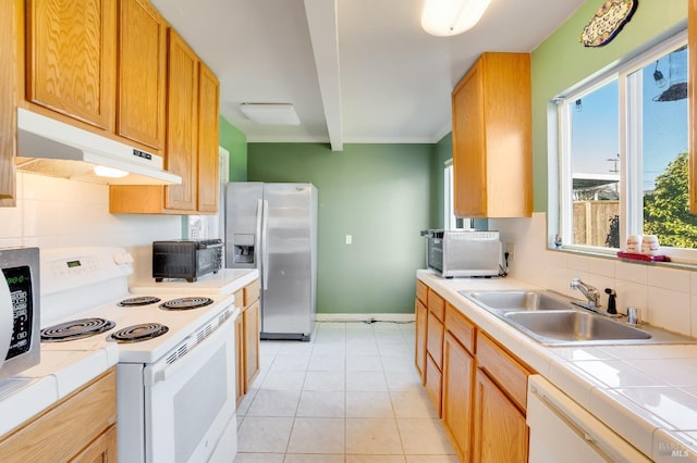 kitchen featuring light tile patterned flooring, sink, tile countertops, white appliances, and decorative backsplash