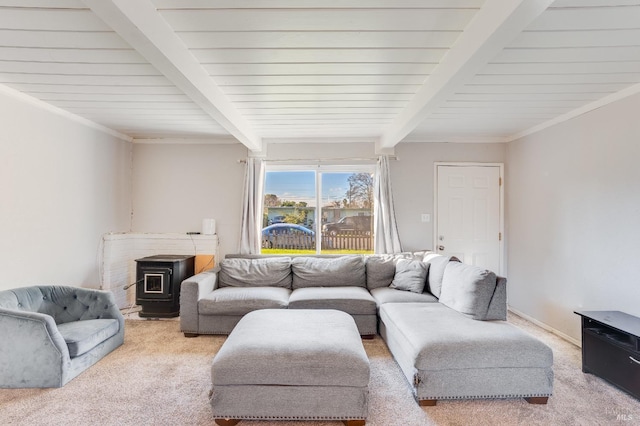 carpeted living room featuring crown molding, beamed ceiling, and a wood stove