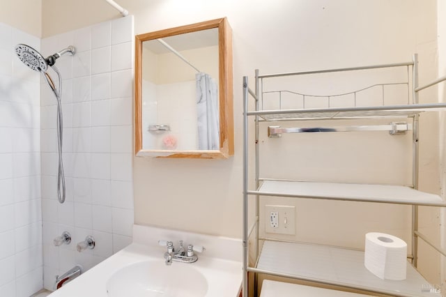 bathroom with sink and shower / bath combo with shower curtain