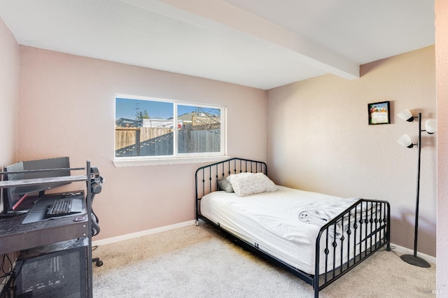 carpeted bedroom featuring beamed ceiling