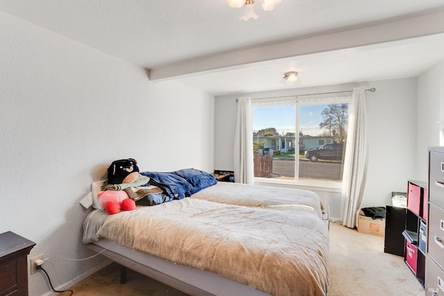 bedroom with light carpet and beam ceiling