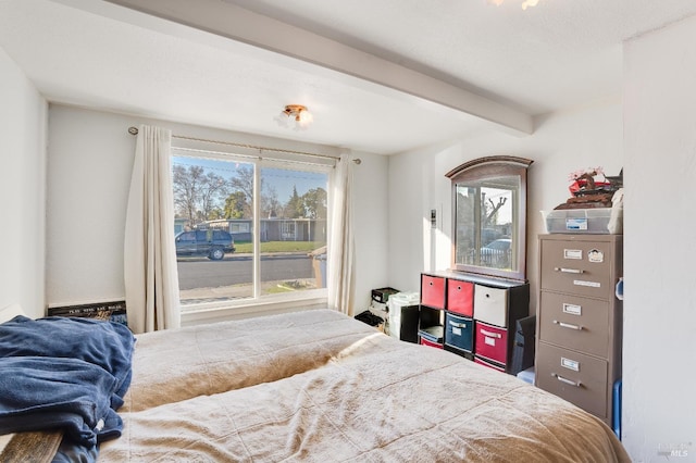 bedroom featuring beamed ceiling