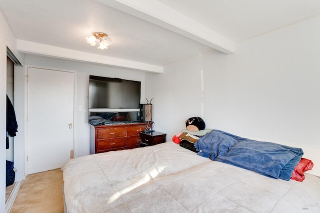 carpeted bedroom featuring beamed ceiling