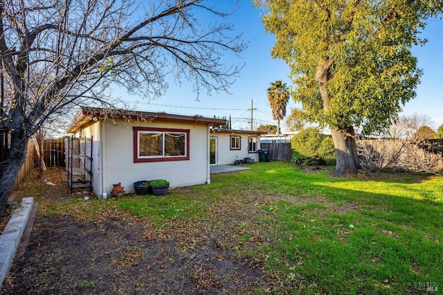 rear view of property with a lawn