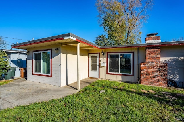 exterior space with a patio area and a front yard