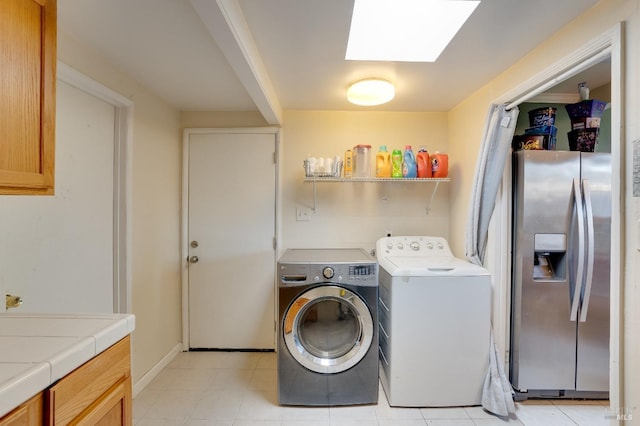 laundry area with separate washer and dryer and a skylight