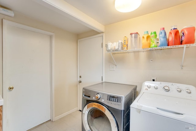 washroom with washer and dryer and light tile patterned flooring